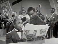 Pianist and Louis Armstrong Reading Magazine