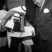 Hasan M. AlJawadi shows his son and daughter his Certificate of Attendance